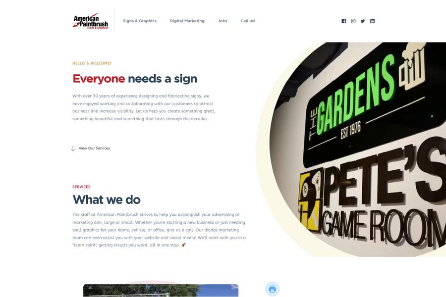 The American Paintbrush homepage Mondo designed and built, with the shop's own photograph of illuminated channel letters filling the right of the page.
